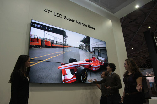 A woman showcasing the 47-inch LED Super Narrow Bezel Display to visitors at ISE 2011.