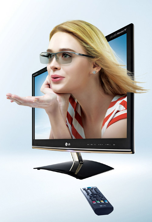 LG 3D monitor model DM50D _With Model (1).jpg A model wearing 3D glasses breaking out of the LG 3D monitor’s (DM50D) display.
