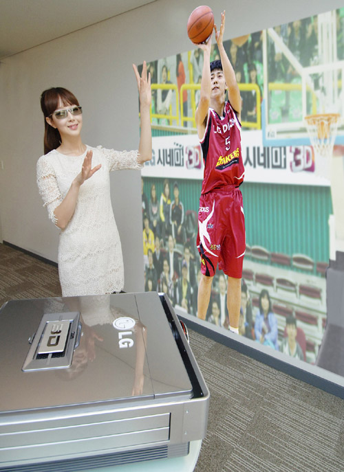 LG CINEMA 3D projector Model CF3DAT_With a Model (1).jpg A model wearing 3D glasses while experiencing the CF3DAT CINEMA 3D projector, which is projecting a basketball player taking a shot