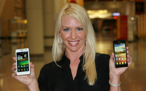 A female model holds white and black LG smartphones and shows its front views