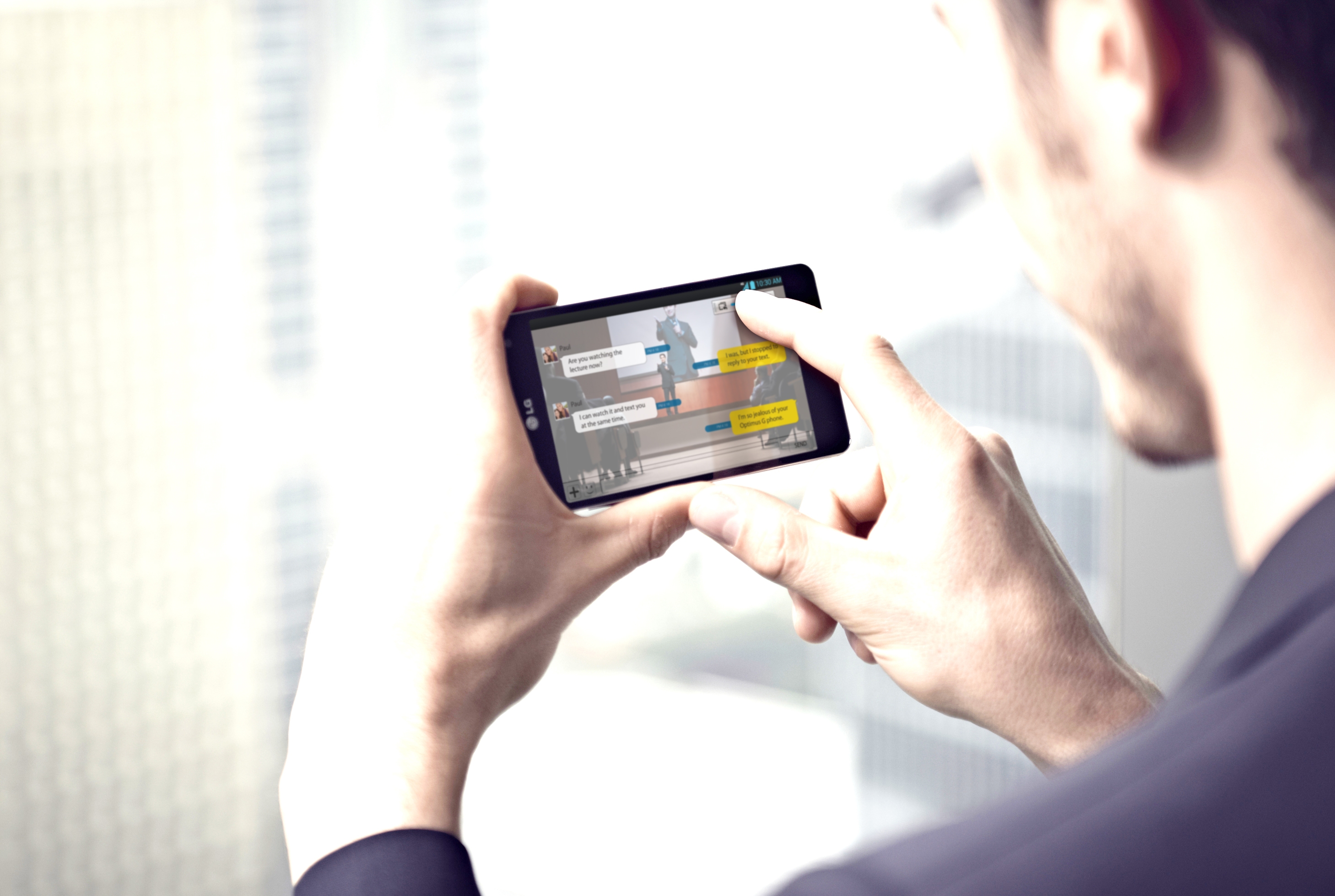 A man is touching a screen of LG Optimus G