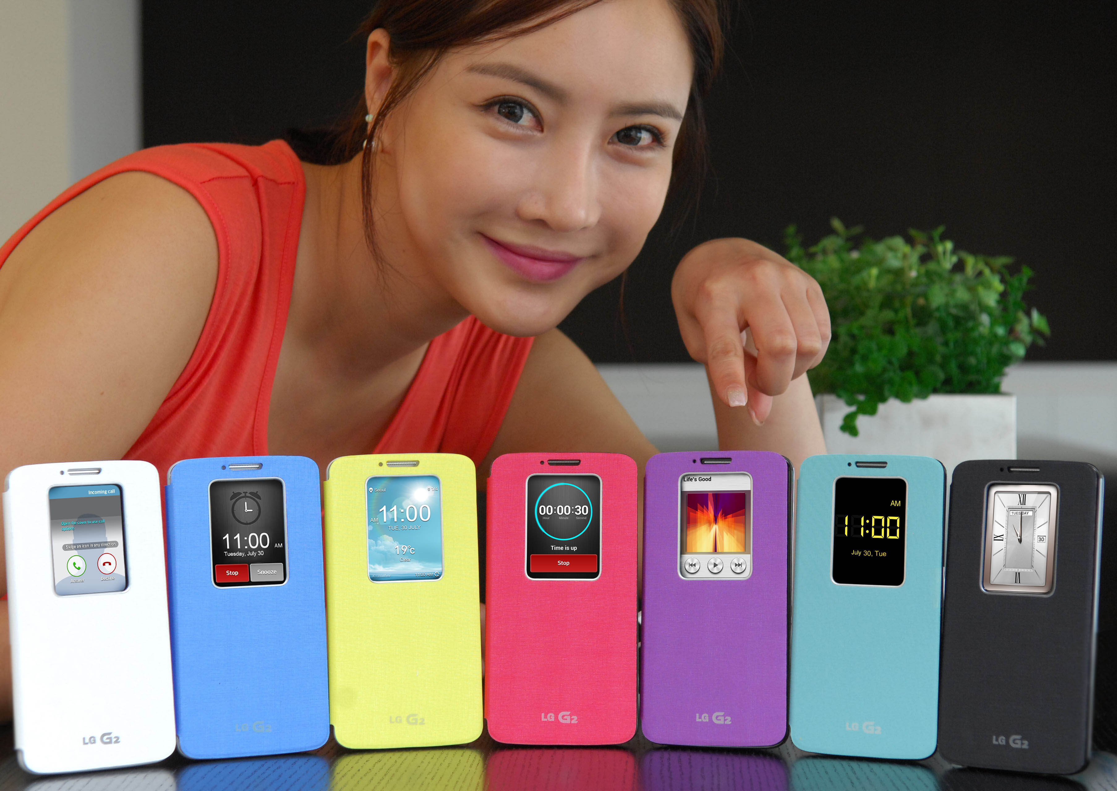 G2s wearing QuickWindowTM cases in seven colors are displayed; white, blue, purple, yellow, pink, mint and black. And a female model is pointing at the purple one.