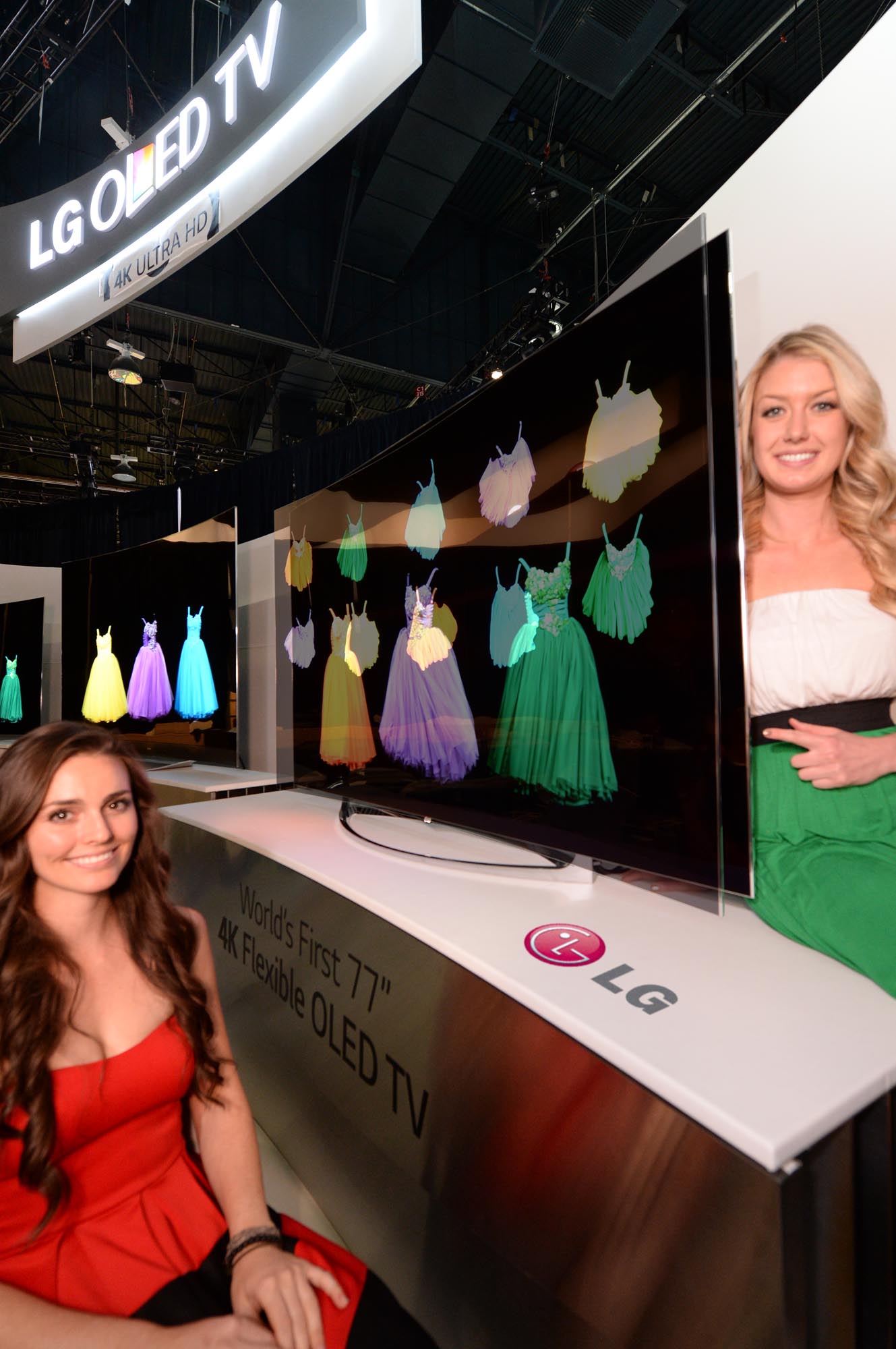 Two models showcasing the world’s first Flexible OLED TV by LG at CES 2014