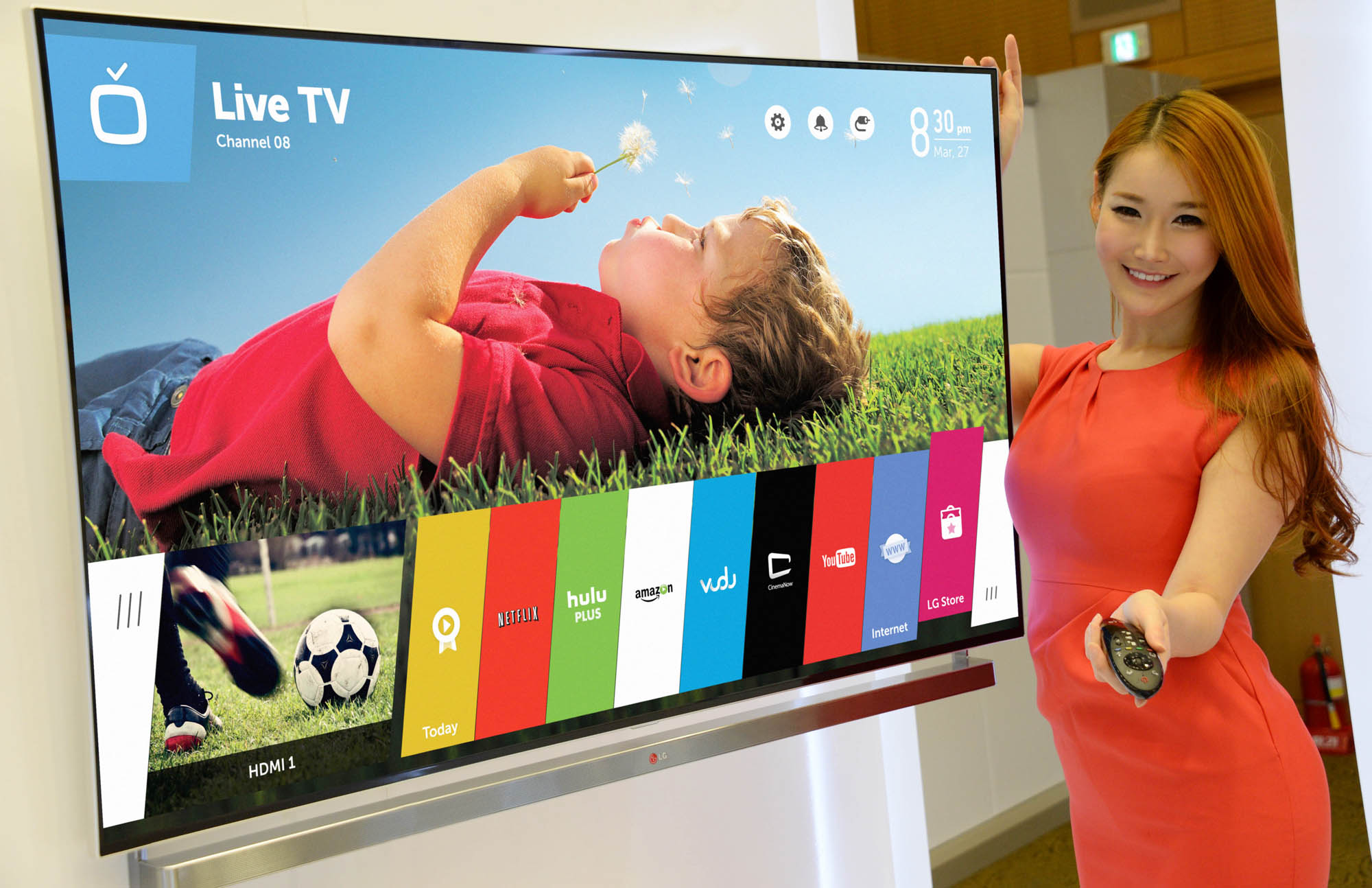 A model showing off LG’s new Smart TV platform webOS with the Magic Remote in her hand