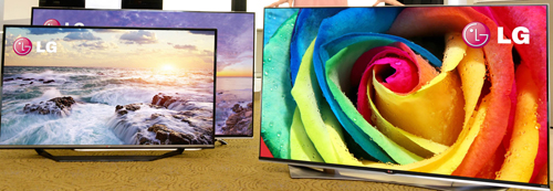 Two side-by-side LG 4K ULTRA HD TVs in the front of another LG TV.