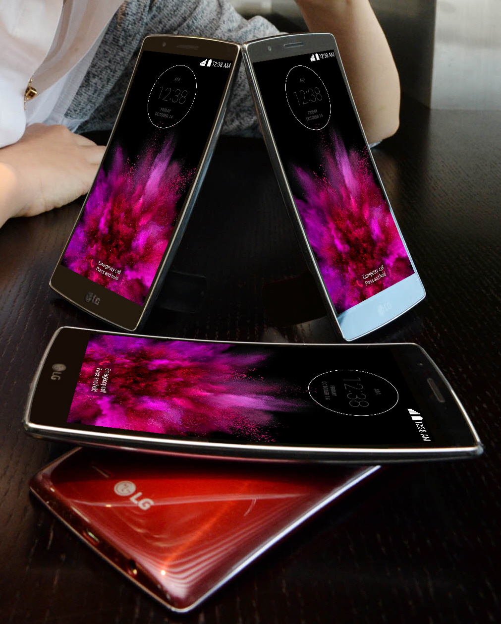 Two LG G Flex2s are standing on the table showing their fronts and other twos are lying on the table – each showing front and back.
