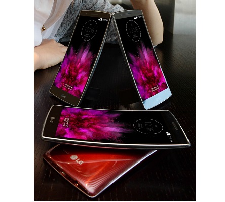 Four LG G Flex 2 smartphones in each color variant are placed on the table and a female model poses behind those sample phones.