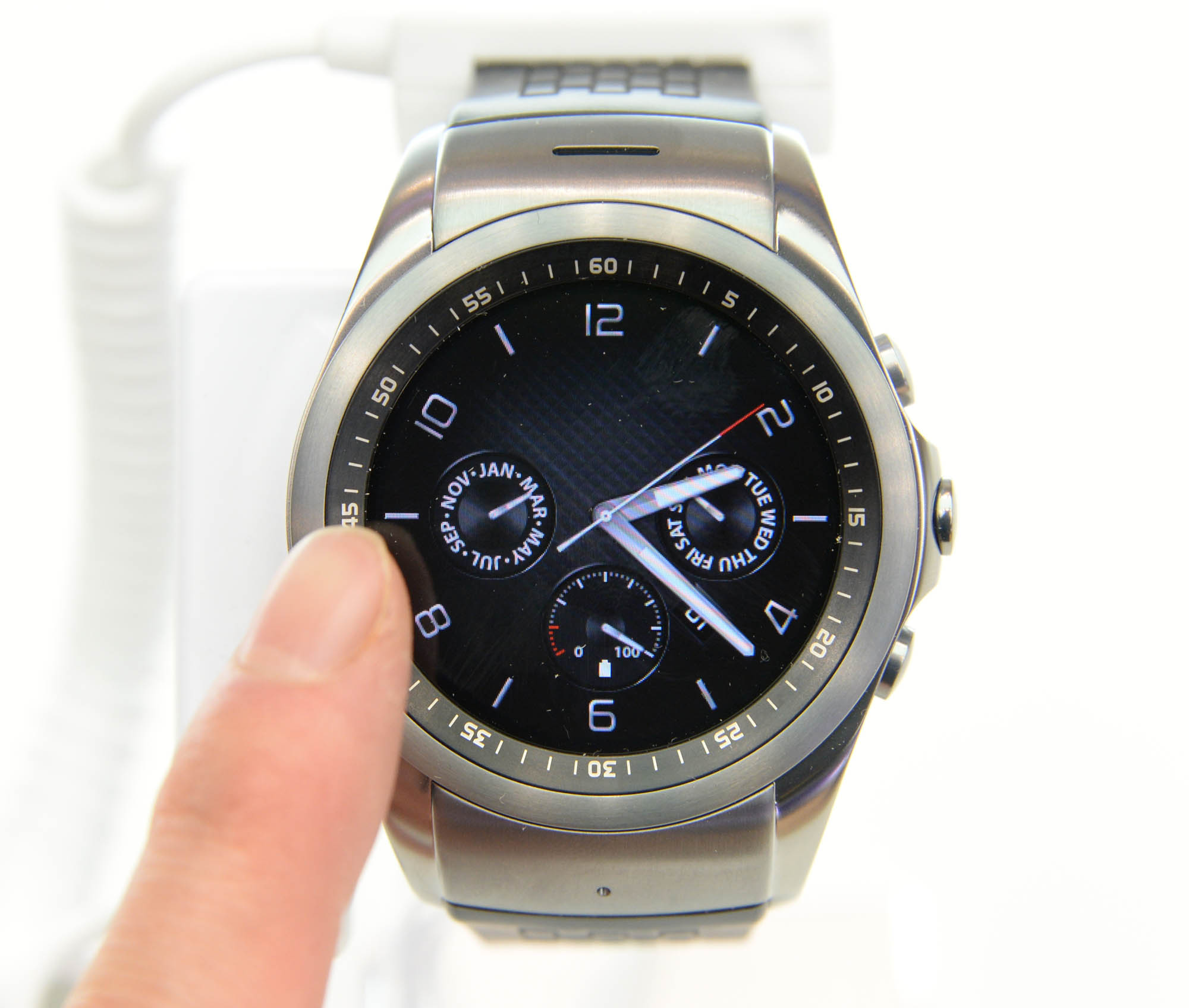 A finger approaching to a LG Watch Urbane.