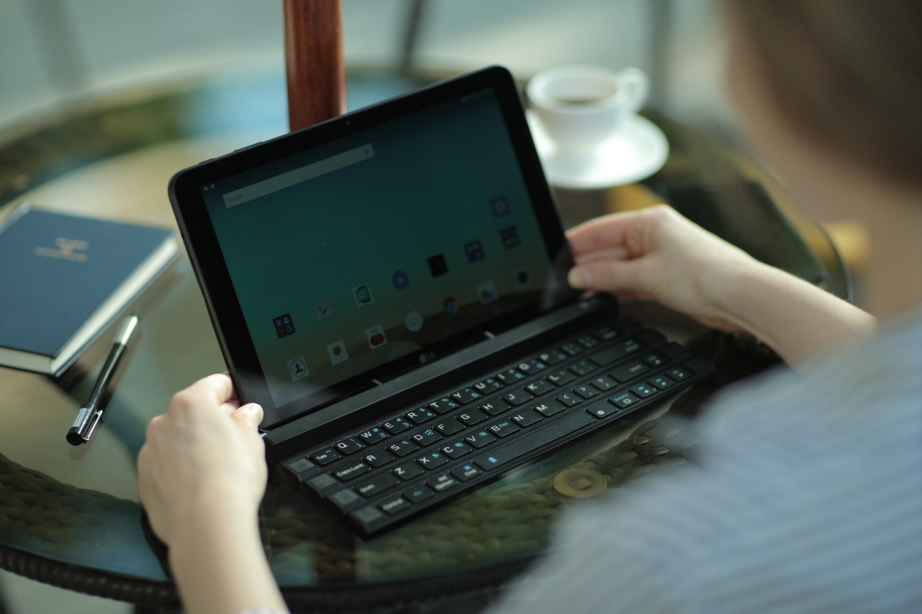 A woman fixing a G pad to the Rolly Keyboard.