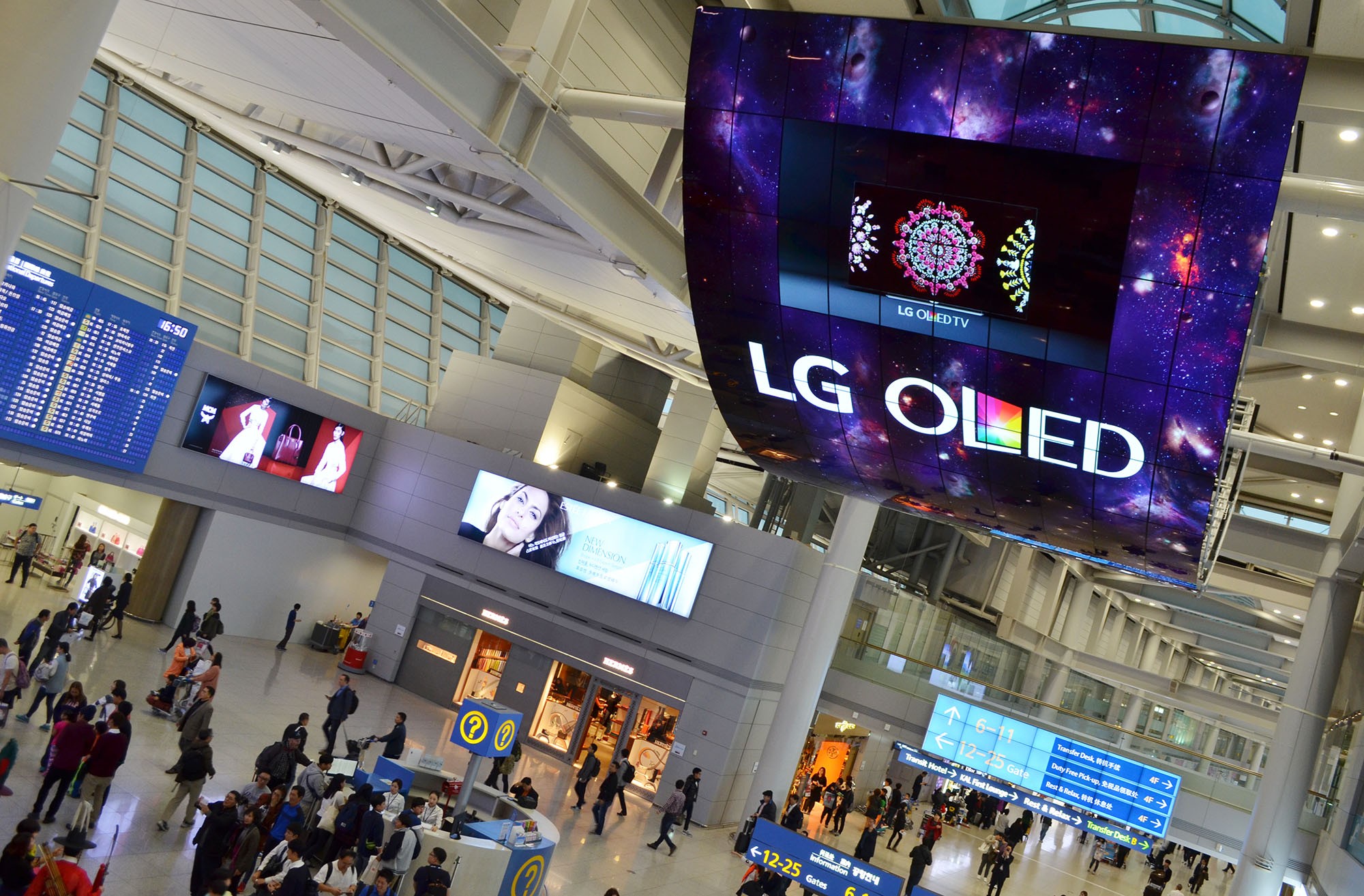 A ceiling installation of LG OLED Signage displaying artwork at Incheon International Airport