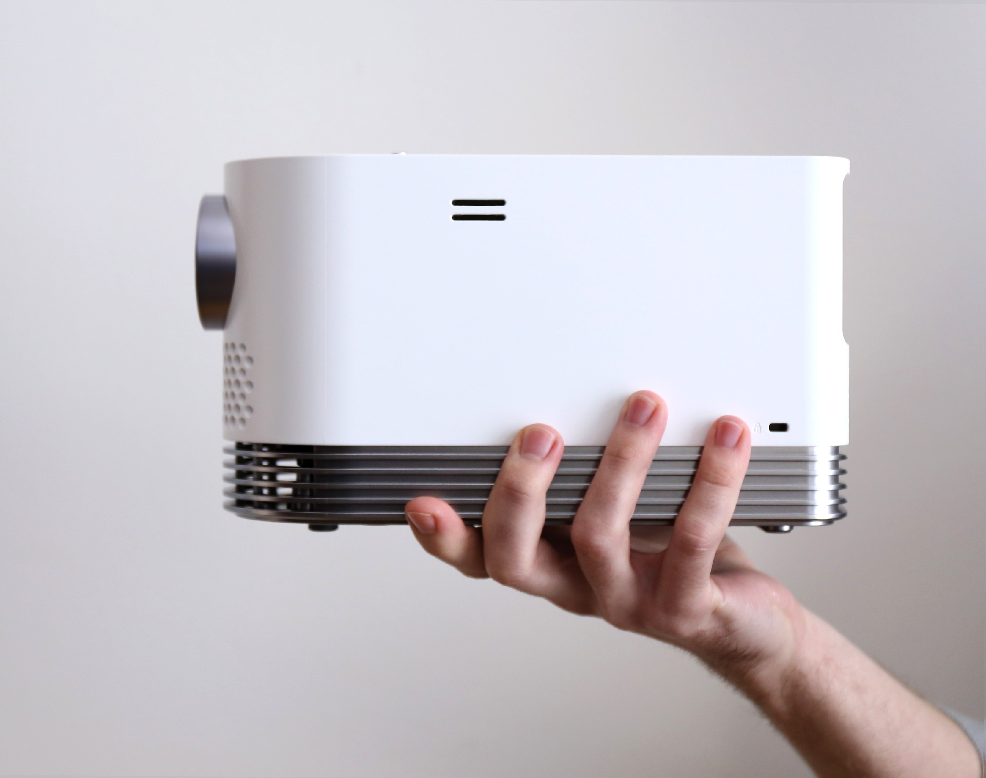 A hand is holding LG ProBeam showing its side view