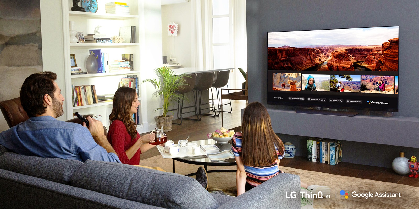 A family watching an LG TV using Google Assistant in their living room