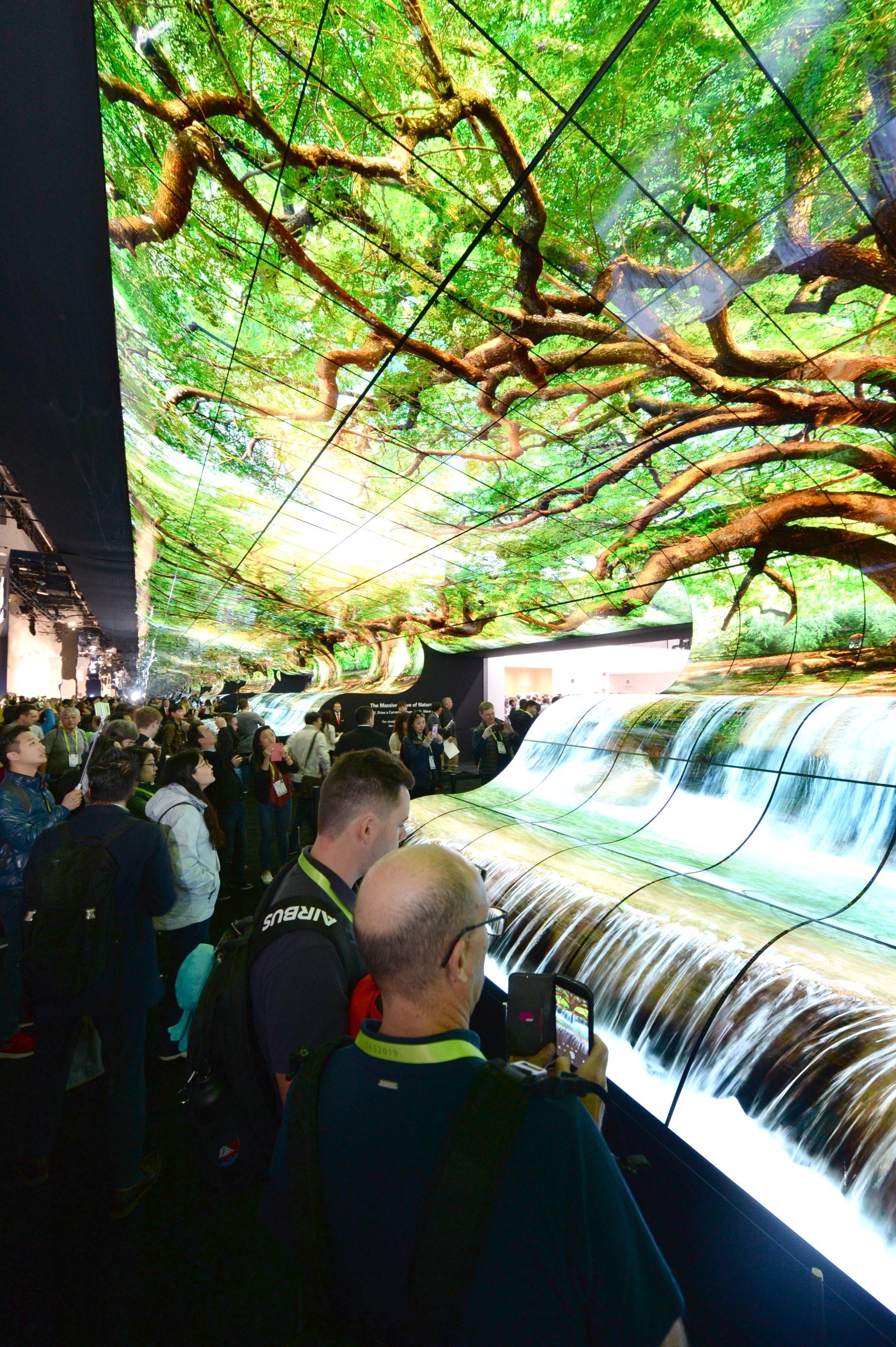 Another view of attendees admiring the LG OLED Falls at the LG Booth at CES 2019