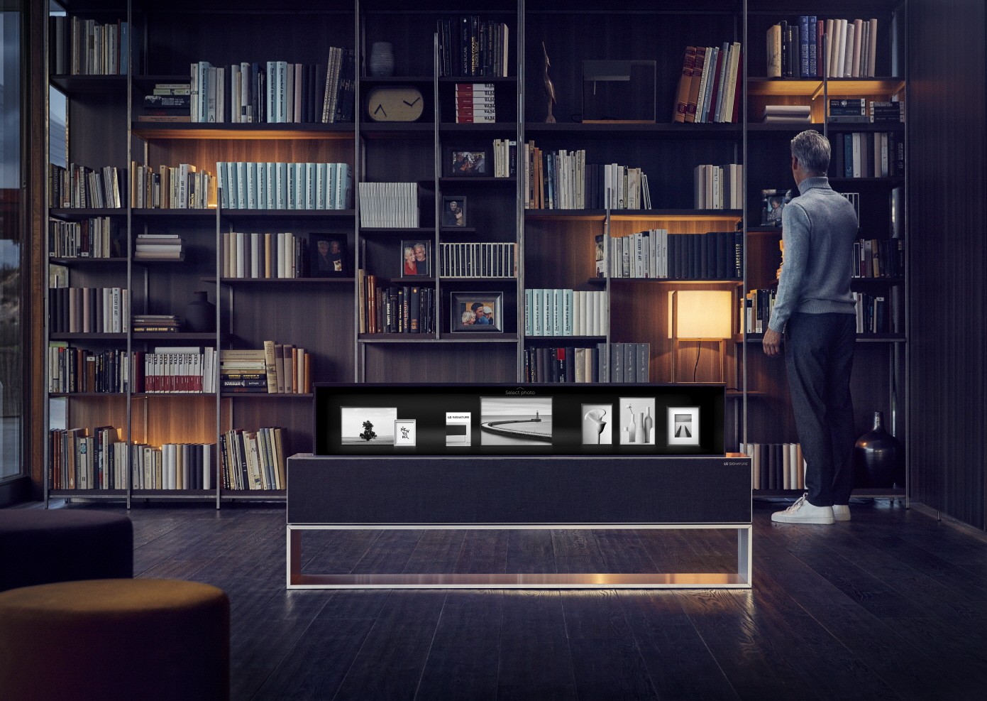 The LG SIGNATURE OLED TV R model 65R9 in its Line View in someone’s study