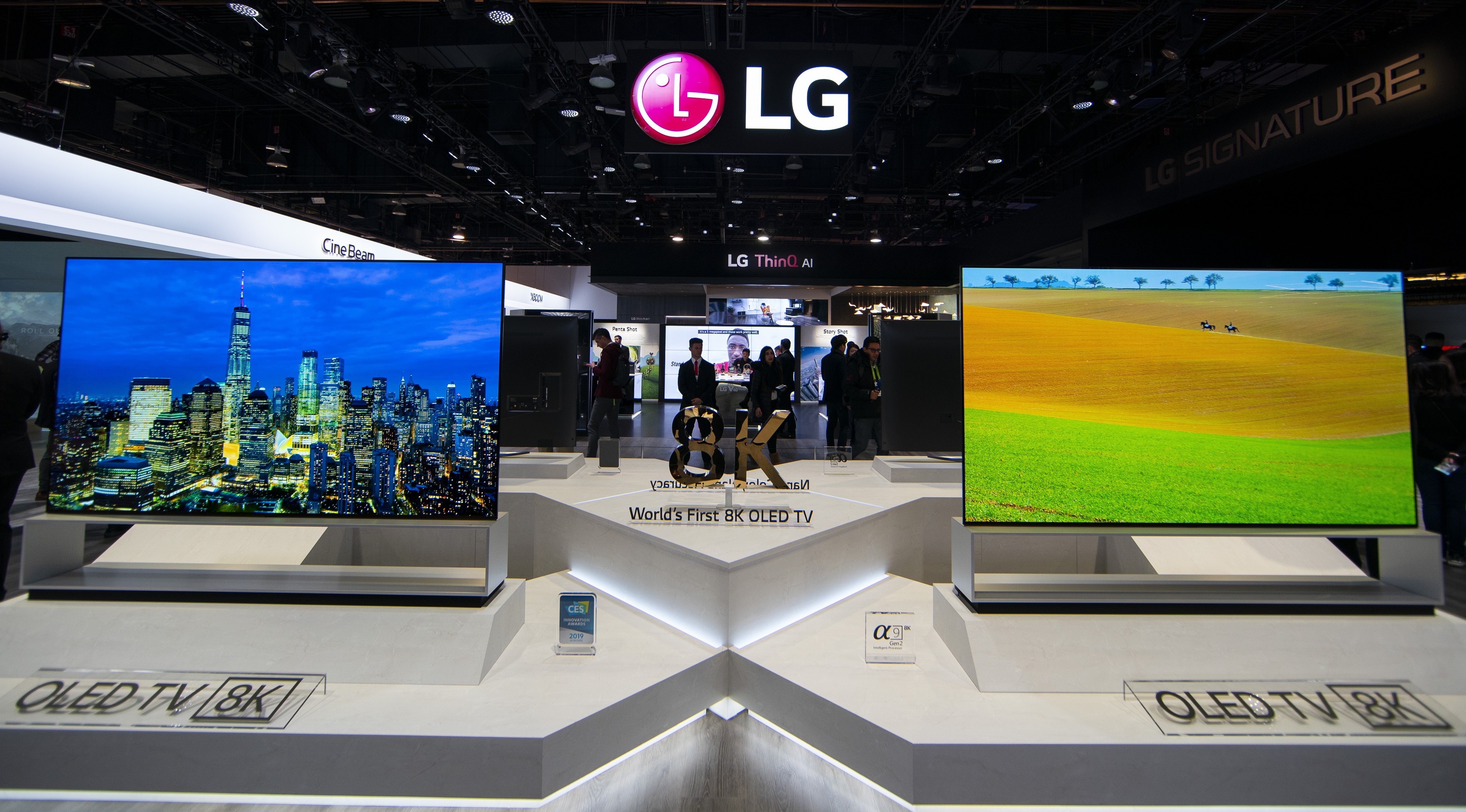 Two LG 8K OLED TVs showing vivid city views and natural landscapes displayed side-by-side