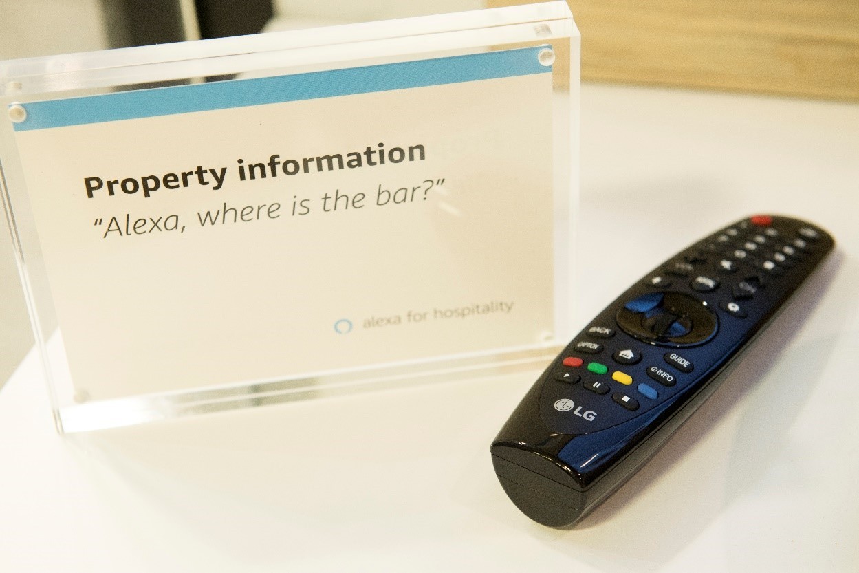 LG’s Magic Remote and a plastic information frame that informs visitors of the voice command, “Alexa, where is the bar?”