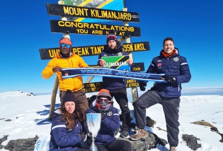 Members of FC Cambounet pose for a group photo at the peak of Mount Kilimanjaro.