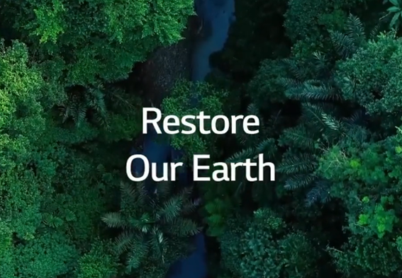 A birds-eye view of a rainforest with a stream running through it and the phrase "Restore Our Earth" overlapping.